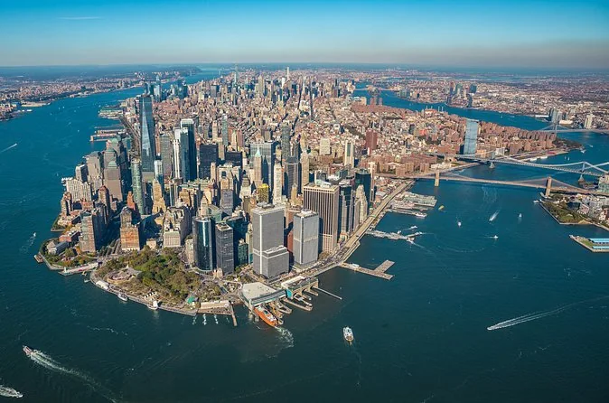 Wide aerial view of Lower Manhattan and the East River bridges on a sunny day