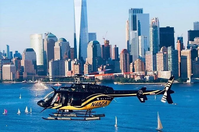 A black and gold tour helicopter flying over the Hudson in front of Lower Manhattan