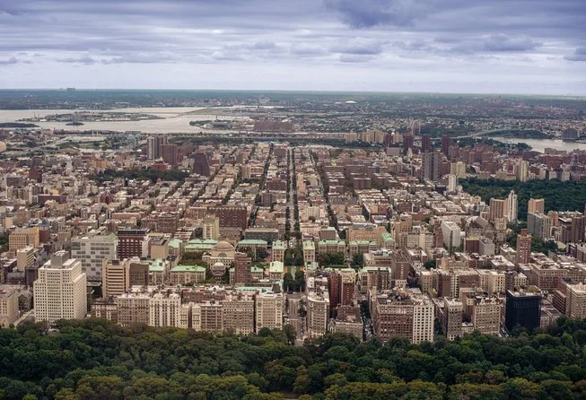Aerial view of Upper Manhattan's apartment blocks with parkland in the foreground